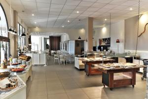 a restaurant with a buffet of food on display at Acrotel Elea Beach in Elia