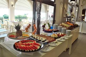 a buffet with many different types of food on a table at Acrotel Elea Beach in Elia