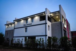 un edificio bianco con luci sul lato di Vulsa Apartmani a Kladovo