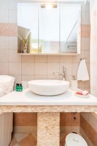 a bathroom with a sink and a toilet at ''Cactus'' Traditional house in Vólax