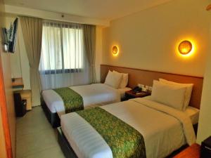 Postel nebo postele na pokoji v ubytování Savvoya Hotel Seminyak