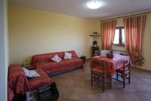 a living room with a couch and a table at Agriturismo Trapletti in Serina