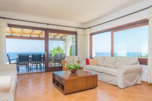 a living room with a couch and a table at Villa Sol Naixent in Cala Ferrera