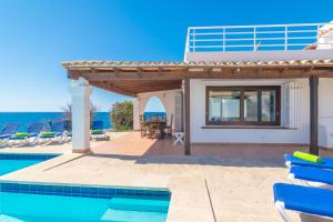 a villa with a swimming pool and a house at Villa Sol Naixent in Cala Ferrera