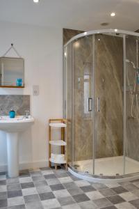 a bathroom with a shower and a sink at Caliburn in Alyth
