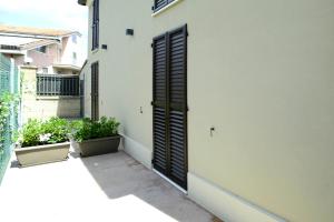 a door on the side of a building with plants at La Casa al Mare in Civitanova Marche