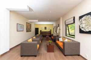 a living room with couches and a table at Melheim Kandy Villas in Kandy