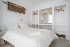 a white bed with two towels on top of it at Κymanemi Folegandros in Agali