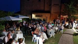 a large group of people sitting at tables at an event at Hotel Locanda San Giacomo in Agliano Terme +56 photos