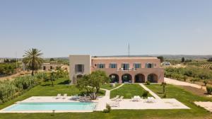 an external view of a villa with a swimming pool at Torre Bonera. Green Resort in Menfi