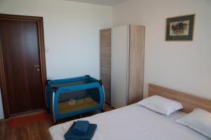 a room with a bed with a tv on it at Apartments Paskalina in Byala +34 photos