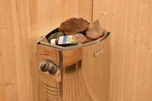 a trash can filled with dirt and rocks at Hotel S.R in Tbilisi City