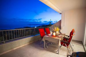 a table and chairs on a balcony with a view at Apartment Edgar in Makarska