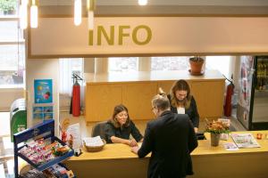 a group of people standing at a counter in a store at Hotel Norrvalla in Vöyri