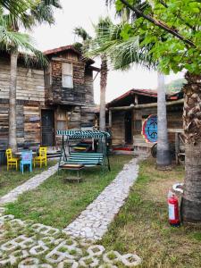 a house with a bench in front of it at Kadir's Family House in Olympos
