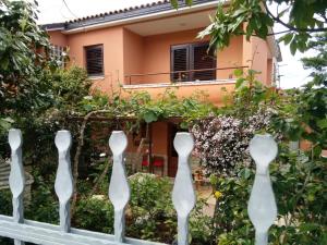 a fence in front of a house at Apartments villa MaVeRo in Banjole
