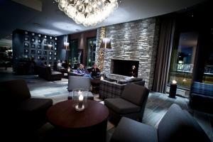 a lobby with couches and a fireplace and a chandelier at Quality Hotel Skifer in Oppdal