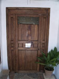 a wooden door in a room with a potted plant at La Casa de Corruco in Casabermeja
