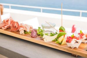 a tray of different types of food on a counter at Dimora Talenti in Polignano a Mare