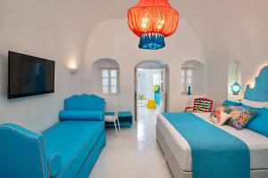 a bedroom with two beds and a chandelier at Barocco Bello Villa in Fira