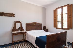 a bedroom with a bed and a dresser and a mirror at Villa Valls in Montuiri +21 photos