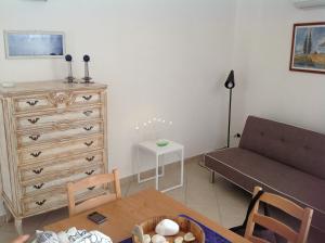 a living room with a couch and a dresser at ALH Hub Living Digitale in Taranto