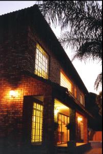 a brick building with windows on the side of it at Falling Feather Inn in Pretoria