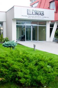 a building with a sign on the front of it at Palangos Linas in Palanga