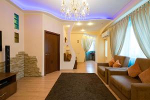 a living room with a couch and a chandelier at Nadezhda Apartments in Keremet Microdistrict in Almaty