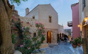 a building with flowers on the side of it at Casa Rodanthi - Luxury Castle Residence in Monemvasia