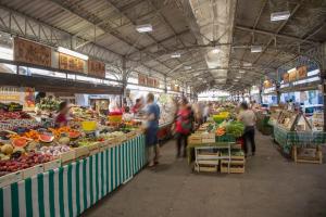 a group of people in a market with fruits and vegetables at Ancre du Cap in Antibes
