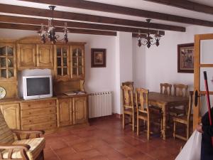 sala de estar con mesa y TV en Casa Rural Arturo I, en Sahagún