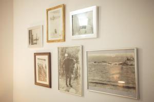 a group of pictures hanging on a wall at The Greek House in Ahtopol +17 photos