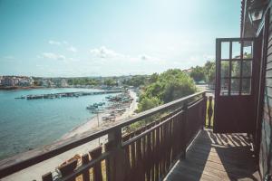 a balcony of a building with a view of a river at The Greek House in Ahtopol