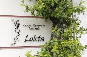 a sign for a restaurant on the side of a building at Hotel Liberty in Levico Terme