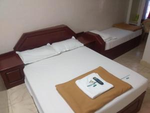 Postel nebo postele na pokoji v ubytování Anandan Tourist Home