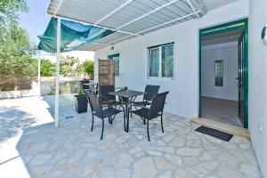 a patio with a table and chairs on a patio at Apartments Magdalena in Hvar