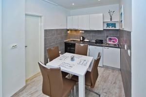 a kitchen with a table and chairs in a room at Apartments Magdalena in Hvar +40 photos