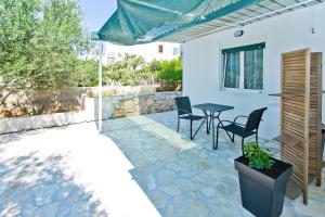 a patio with a table and chairs in a house at Apartments Magdalena in Hvar