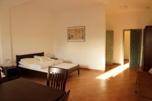 a bedroom with a bed and a table in it at Dom Gościnny Klemens in Dębki