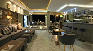 a hotel lobby with a couch and a bar at Golden Star City Resort in Perea
