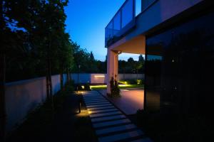 a house with lights on the outside of it at Apartamenty 242 in Toruń