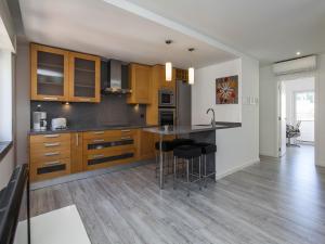 a kitchen with wooden cabinets and a counter top at Cascais SENSATIONS in Cascais