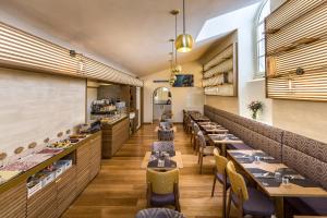 a restaurant with tables and chairs in a room at Hotel La Scaletta al Ponte Vecchio in Florence