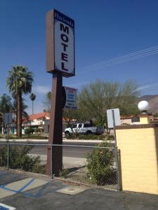 a sign for a motel on the side of a street at Hacienda Motel in San Jacinto