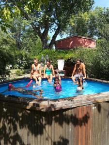 a group of people sitting in a swimming pool at Ca' Barbona in Lido di Classe +91 photos