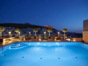 a swimming pool on the roof of a building at night at Athens Zafolia Hotel in Athens