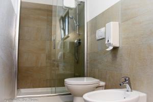 a bathroom with a shower and a toilet and a sink at Agriturismo San Matteo in Tarquinia