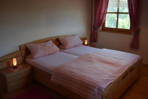 a bed in a bedroom with two candles on it at Ferienwohnung Kagerbauer Christiane in Lindberg