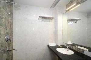 a bathroom with a sink and a mirror at Lilypool - The Heritage Jalmahal in Jaipur +21 photos